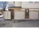 Close up of multi-Gathering garage doors featuring house numbers and parking signage at 3866 S Dallas Cir # 201, Aurora, CO 80014
