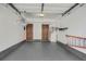 Spacious garage interior showcasing ample storage space, gray floors and access doors at 3866 S Dallas Cir # 201, Aurora, CO 80014