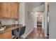 Hallway featuring built-in desk, hardwood flooring, leading to bathroom at 3866 S Dallas Cir # 201, Aurora, CO 80014