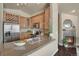 Modern kitchen featuring granite counters, stainless appliances, and view of fireplace at 3866 S Dallas Cir # 201, Aurora, CO 80014