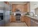 Modern kitchen featuring stainless steel appliances, granite countertops, and ample cabinet space at 3866 S Dallas Cir # 201, Aurora, CO 80014
