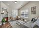 Bright living room with hardwood floors, modern fireplace, vaulted ceilings, and natural light at 3866 S Dallas Cir # 201, Aurora, CO 80014