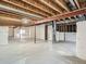 Unfinished basement with utilities, concrete floor, exposed joists and beams awaiting customization at 7746 S Valdai Ct, Aurora, CO 80016