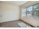 Cozy bedroom featuring plush carpet, large window, and ample natural light at 7746 S Valdai Ct, Aurora, CO 80016