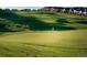 Scenic golf course view with manicured green and residential homes in the background at 7746 S Valdai Ct, Aurora, CO 80016