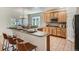 Well-equipped kitchen with a breakfast bar and wooden cabinetry overlooking the backyard at 7746 S Valdai Ct, Aurora, CO 80016