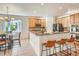 Beautiful kitchen with a breakfast bar and ample wooden cabinet space adjacent to the dining area at 7746 S Valdai Ct, Aurora, CO 80016