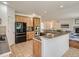 Modern kitchen featuring a breakfast bar and generous wooden cabinets for storage with stainless appliances at 7746 S Valdai Ct, Aurora, CO 80016