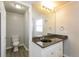 Bathroom with granite vanity top, dark basin sink, a large mirror, and modern lighting at 17209 E Evans Dr, Aurora, CO 80013