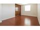 Bedroom features laminate flooring, a window, and a closet with sliding doors at 17209 E Evans Dr, Aurora, CO 80013