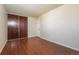 Bedroom features dark wood floors, and a closet with dark wood sliding doors at 17209 E Evans Dr, Aurora, CO 80013