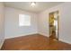 Cozy room featuring wood floors, white walls, window, and an open doorway to kitchen at 17209 E Evans Dr, Aurora, CO 80013