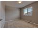 This bedroom features neutral walls, carpet, and a large window for natural light at 16544 E 118Th Dr, Commerce City, CO 80022