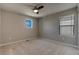 Empty carpeted bedroom with two windows providing natural light at 16544 E 118Th Dr, Commerce City, CO 80022
