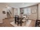 Cozy dining area featuring wood-style floors, modern table, and staircase access at 16544 E 118Th Dr, Commerce City, CO 80022