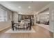 Bright open-concept dining area with sleek table, seating for six, and wood flooring at 16544 E 118Th Dr, Commerce City, CO 80022