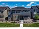 Charming home with a stone facade, covered porch, and manicured front lawn at 16544 E 118Th Dr, Commerce City, CO 80022