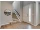Bright foyer with hardwood floors, staircase, and a view into the kitchen at 16544 E 118Th Dr, Commerce City, CO 80022