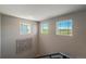 Upstairs hallway with views from three windows and modern black and white artwork at 16544 E 118Th Dr, Commerce City, CO 80022
