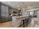 Stylish kitchen with gray cabinets, island seating, and stainless steel appliances at 16544 E 118Th Dr, Commerce City, CO 80022
