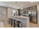 Modern kitchen with stainless steel appliances, gray cabinets, and granite countertops at 16544 E 118Th Dr, Commerce City, CO 80022