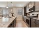 Granite kitchen island, stainless steel oven/cooktop and modern sink at 16544 E 118Th Dr, Commerce City, CO 80022