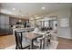 Open-concept kitchen, dining and living area with stainless steel appliances and wood flooring at 16544 E 118Th Dr, Commerce City, CO 80022