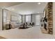 Bright living room featuring a stone fireplace and neutral-toned furnishings at 16544 E 118Th Dr, Commerce City, CO 80022