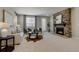 Cozy living room with a stone fireplace and neutral decor at 16544 E 118Th Dr, Commerce City, CO 80022