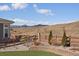 Landscaped backyard with decorative block wall, fence, and views of mountains at 9443 Torrey Way, Arvada, CO 80007