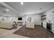 Finished basement featuring a living area, bar with a waterfall island, and wood floors at 9443 Torrey Way, Arvada, CO 80007