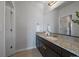 Bathroom featuring granite countertops, sink, and a large mirror at 9443 Torrey Way, Arvada, CO 80007