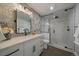 Modern bathroom with mosaic accent wall, glass shower, and white vanity at 9443 Torrey Way, Arvada, CO 80007
