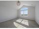 Bright bedroom featuring a vaulted ceiling and a large window with scenic outdoor views at 9443 Torrey Way, Arvada, CO 80007