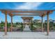 Charming community garden with raised beds, a pergola-covered entrance, and a secure fence at 9443 Torrey Way, Arvada, CO 80007