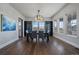 Dining room with hardwood floors, stylish chandelier, and natural light, perfect for gatherings at 9443 Torrey Way, Arvada, CO 80007