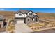 Beautiful two-story home with a stone and stucco facade, manicured lawn, and a two-car garage at 9443 Torrey Way, Arvada, CO 80007