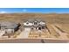 Two-story home featuring a stone and stucco facade, attached garage, and a manicured front yard at 9443 Torrey Way, Arvada, CO 80007