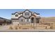 Charming two-story home featuring stone accents, a well-maintained lawn, and an attached garage at 9443 Torrey Way, Arvada, CO 80007