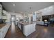Spacious kitchen with granite counters, stainless appliances, and open to the living room fireplace at 9443 Torrey Way, Arvada, CO 80007