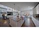 Open concept kitchen with large island, copper sink, and views into adjacent living and dining areas at 9443 Torrey Way, Arvada, CO 80007