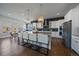 Bright kitchen with white cabinets, stainless appliances, and center island with bar stool seating at 9443 Torrey Way, Arvada, CO 80007