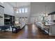 Open-concept living room with a kitchen featuring a large island with barstool seating at 9443 Torrey Way, Arvada, CO 80007