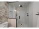 Modern bathroom features a large glass shower, mosaic wall, and neutral tile at 9443 Torrey Way, Arvada, CO 80007