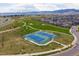 Aerial view of two well-maintained community tennis courts surrounded by green space and walking paths at 9443 Torrey Way, Arvada, CO 80007