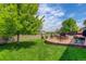 Spacious backyard with a fire pit, mature trees and landscaping at 24351 E Alamo Dr, Aurora, CO 80016