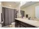 Bathroom featuring double sinks, dark wood cabinets, a shower curtain, and a toilet at 24351 E Alamo Dr, Aurora, CO 80016