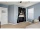 Light blue bedroom with carpet and a closet hidden behind black curtains at 24351 E Alamo Dr, Aurora, CO 80016