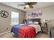 Comfortable carpeted bedroom with Texas themed decorations and wall art with a large window at 24351 E Alamo Dr, Aurora, CO 80016