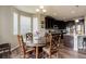 Cozy dining area with wood floors, chandelier and dark wood kitchen cabinets in the background at 24351 E Alamo Dr, Aurora, CO 80016